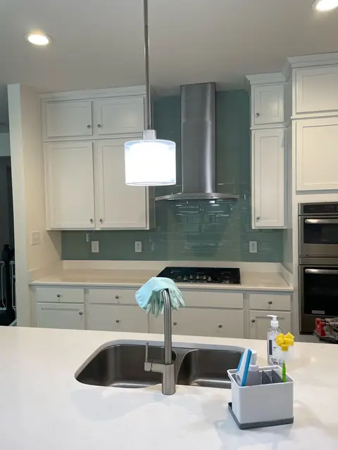 Kitchen with a teal glass tile backsplash