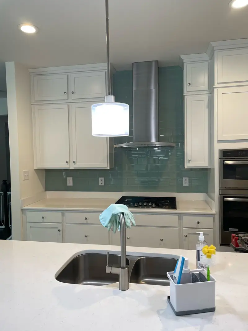 Kitchen with a teal glass tile backsplash