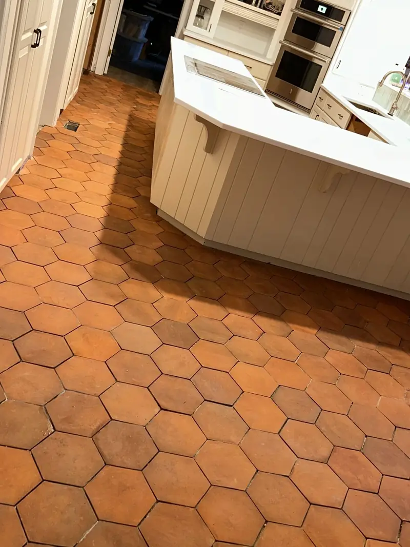 Terracotta hexagon tile floor running through a kitchen