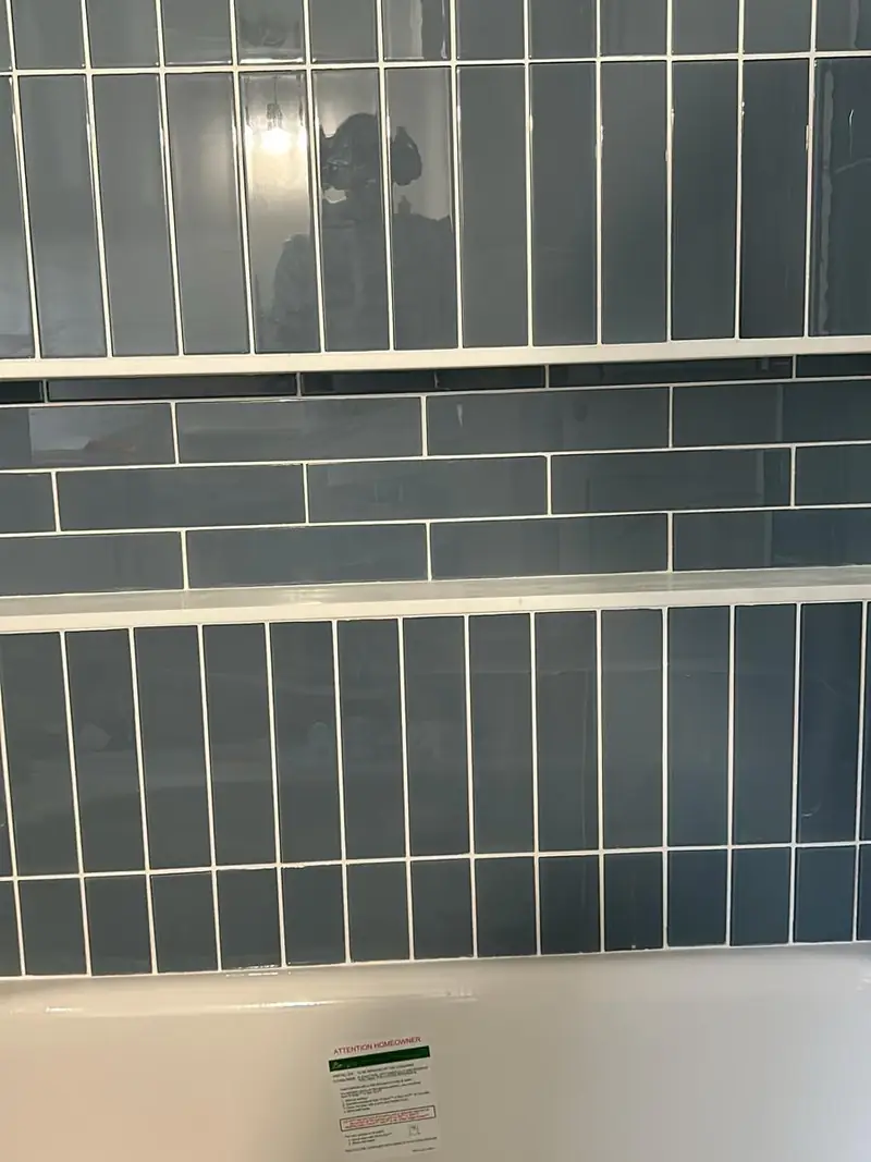 Slate-blue tile wall above a bathtub